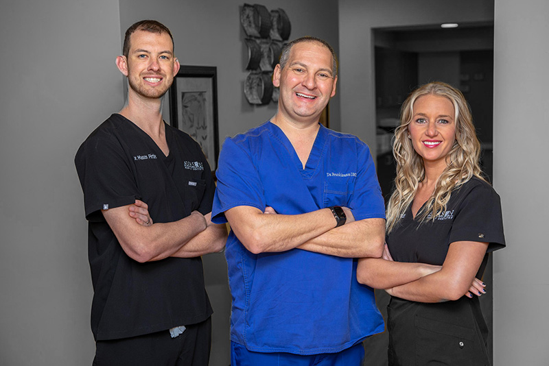 dr avason dr wolff and dr pirtle in scrubs standing together with arms crossed and smiling