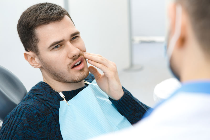 Dental Patient Suffering From Mouth Pain On A Dental Chair, In Denver, NC