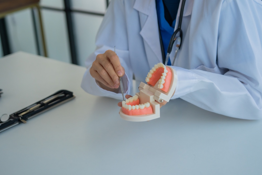 Dentist consulting with patient about teeth replacement options